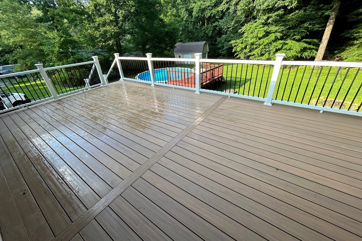 Composite deck boards and white rail on a rebuilt deck by MDM Painting & Remodeling, Reading